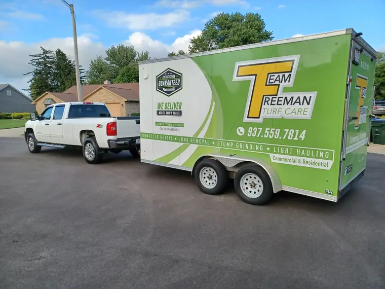 Team Freeman Turf Care truck and branded trailer on a job in Dayton, Ohio